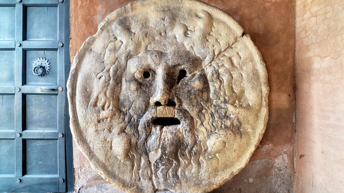 a stone face on the side of a wall