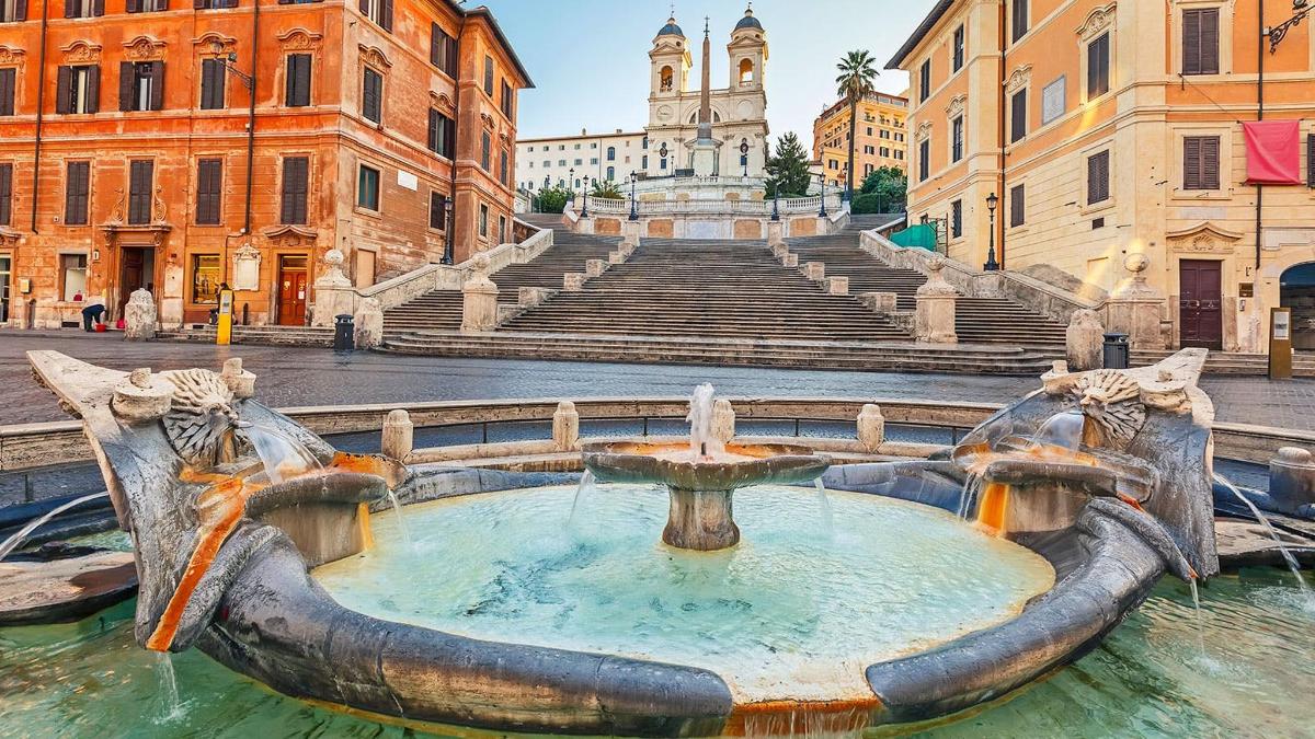 a fountain in the middle of a city with buildings