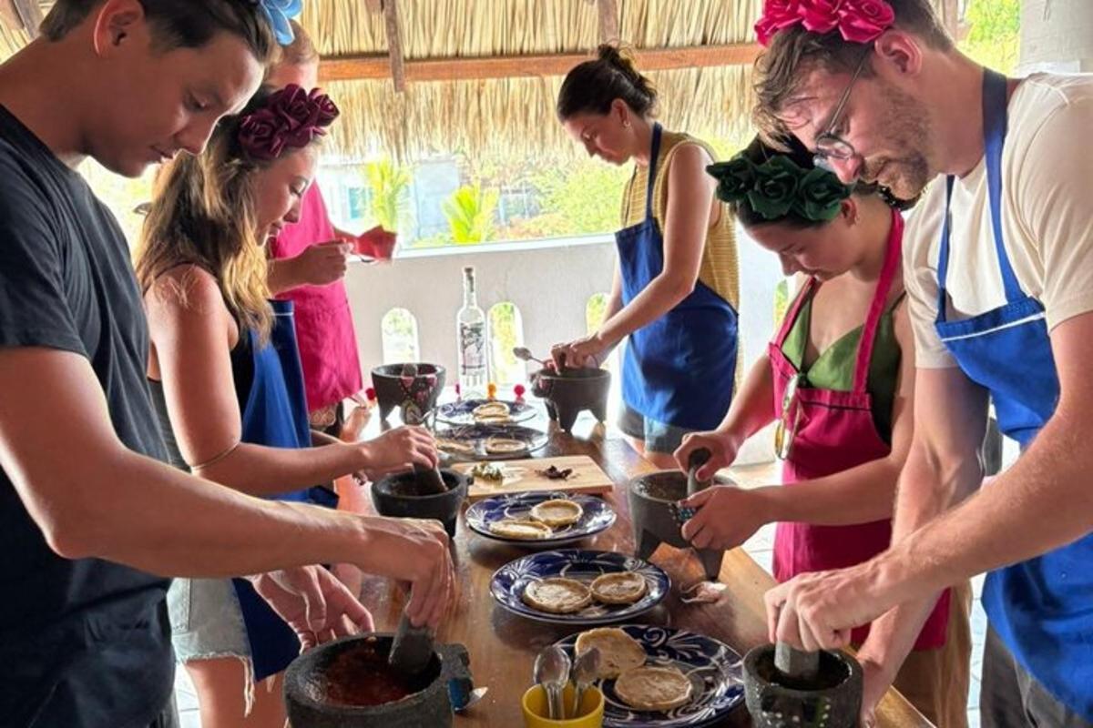 a group of people standing around a table preparing food