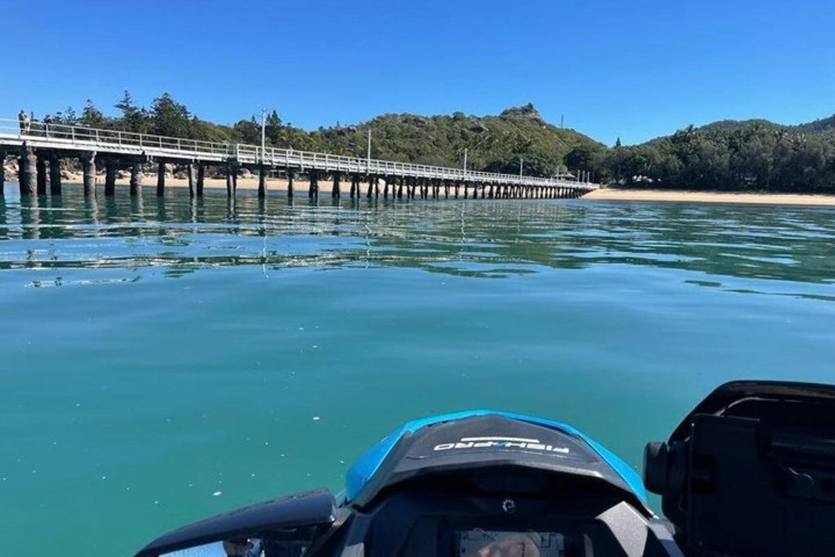 a boat in the water next to a pier