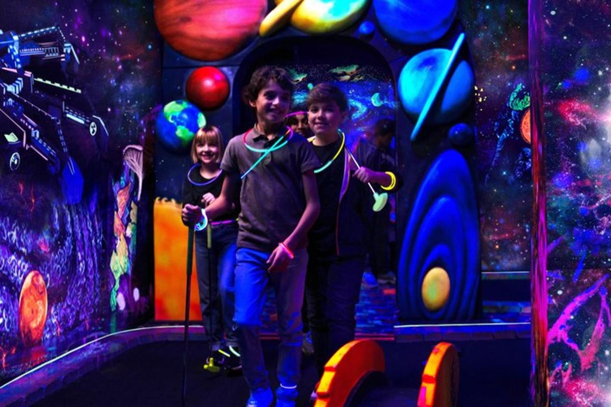 two young boys standing in front of a room with planets