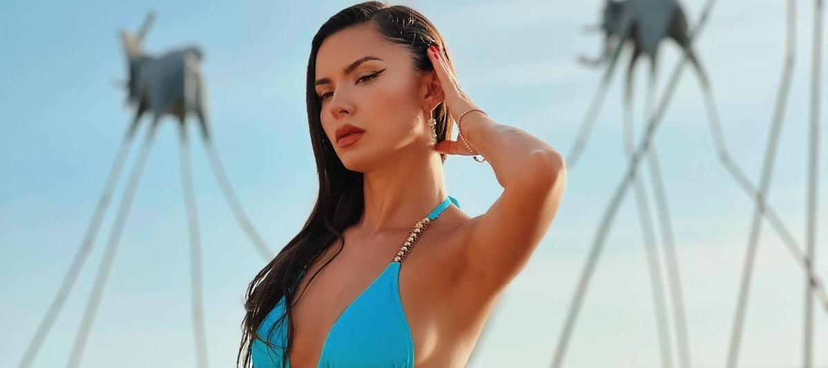 a woman in a blue dress on the beach