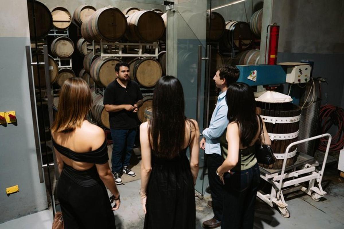 a group of people standing in a room with barrels