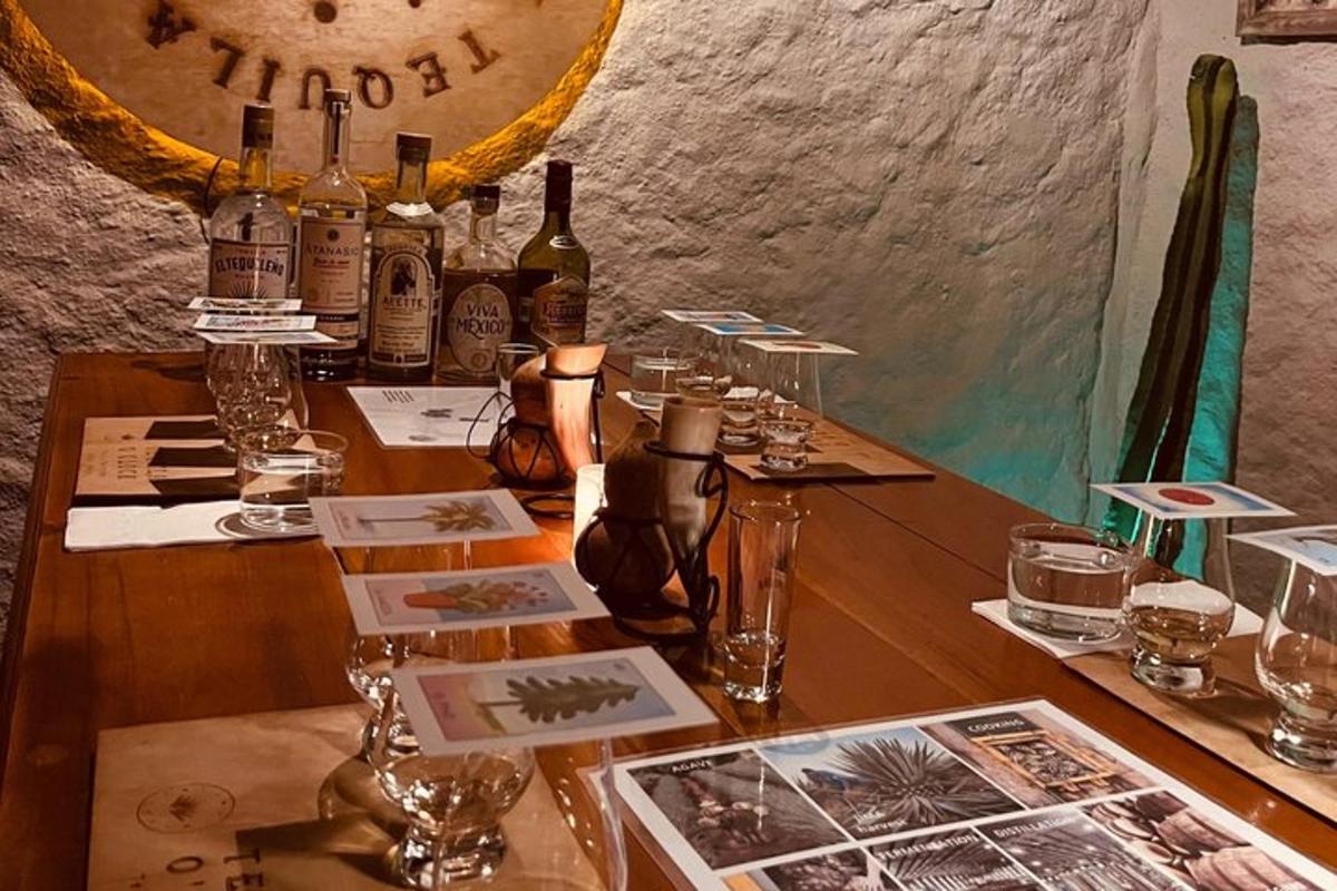 a wooden table with bottles of wine and glasses