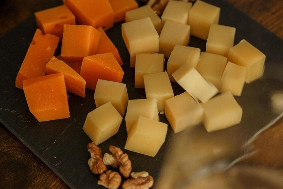 a plate with cheese and nuts on a table