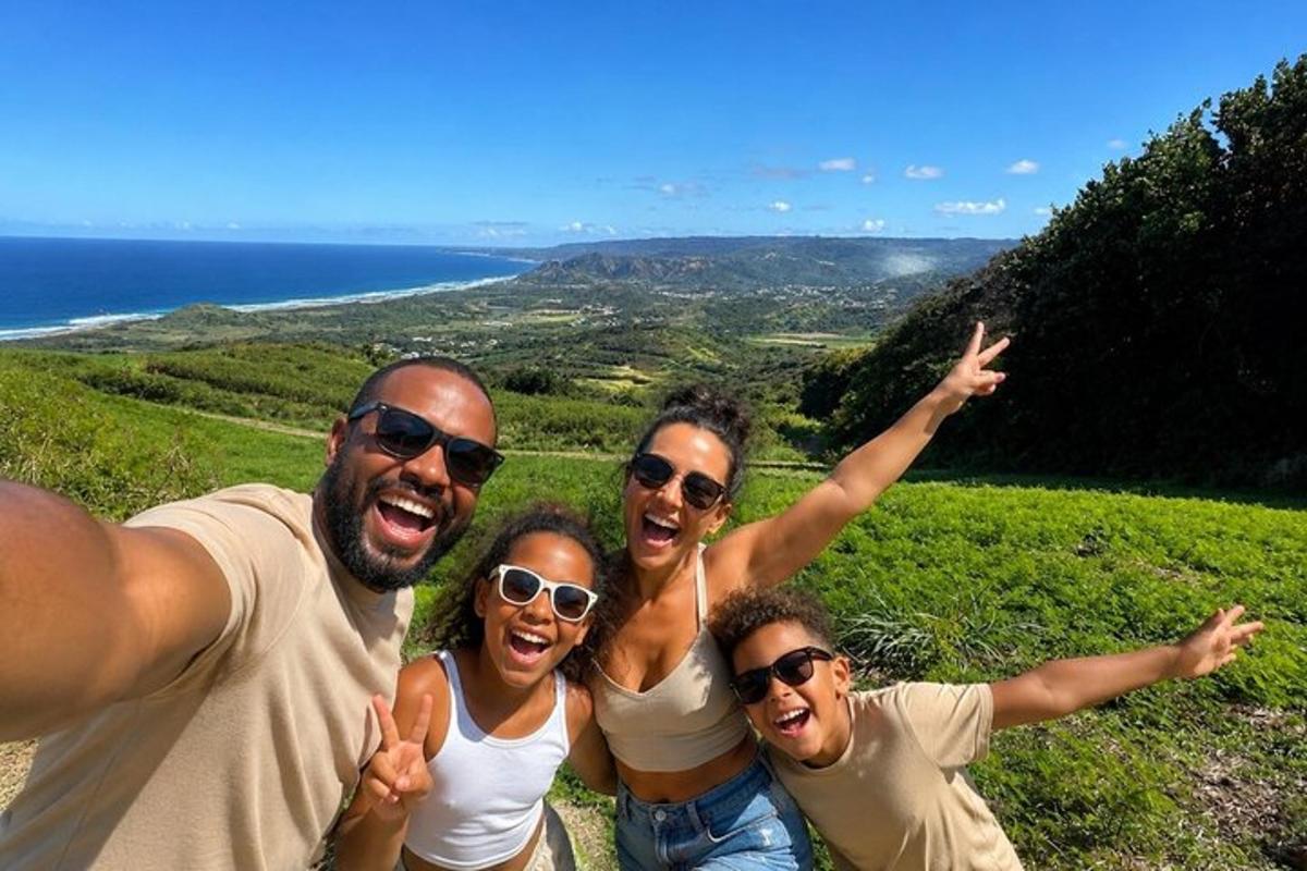 a group of people posing for a picture on a hill