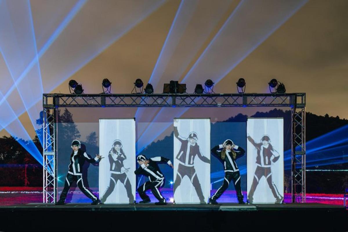 a group of people walking on a stage