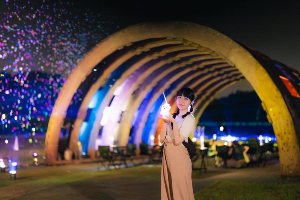 a woman in a dress holding a knife in front of a tunnel