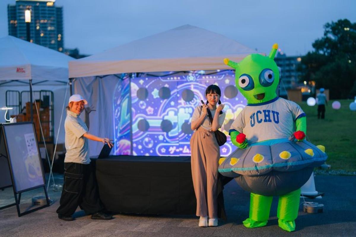 a man and a woman standing in front of a screen