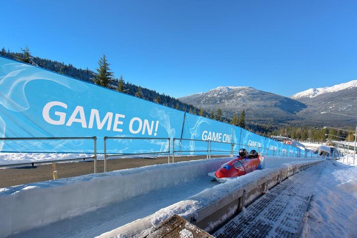 two people on a snowmobile on a race track