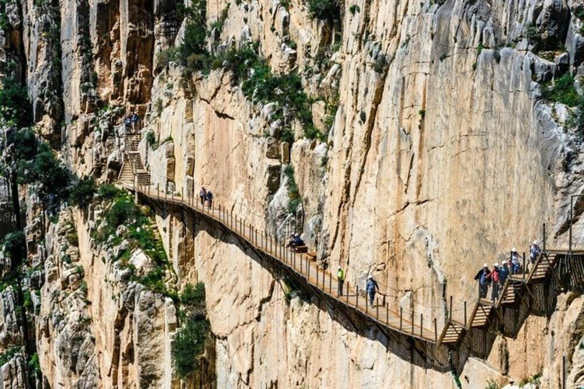 a group of people on a bridge on a mountain