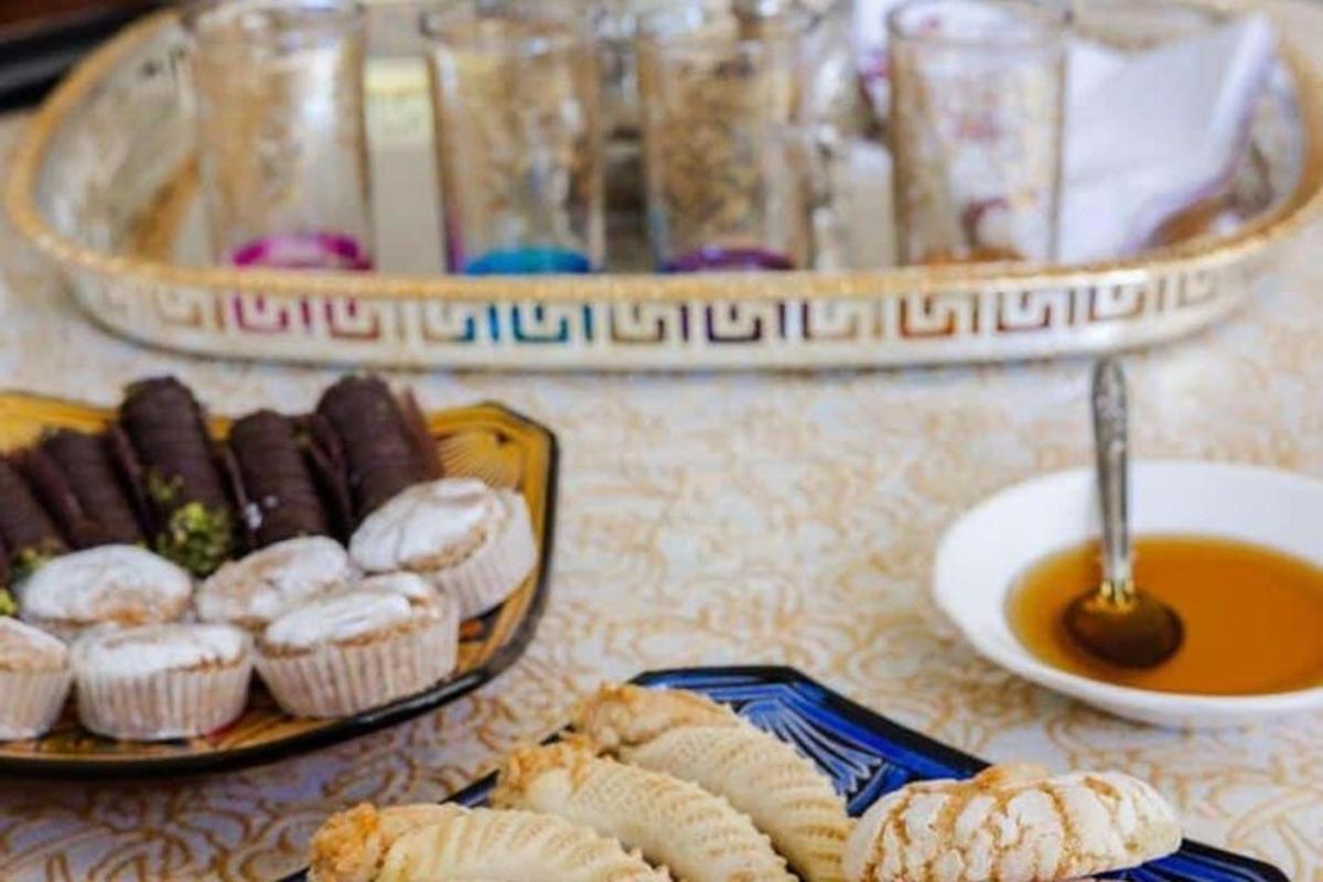 a table with two plates of pastries and a bowl of soup