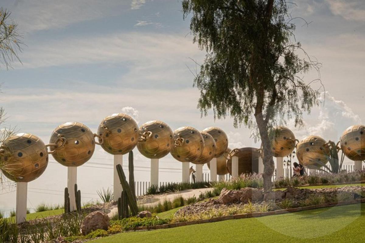 a group of spheres on display in a park