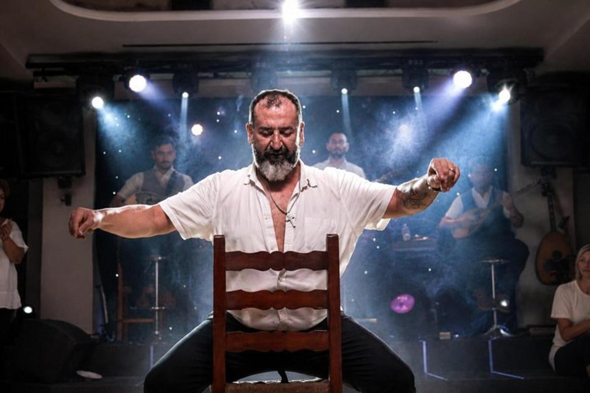 a man sitting in a chair with his arms out
