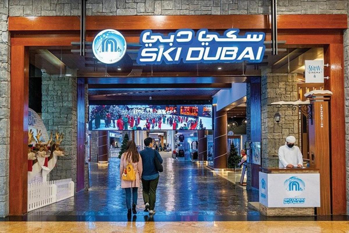 two people walking inside of a shopping mall