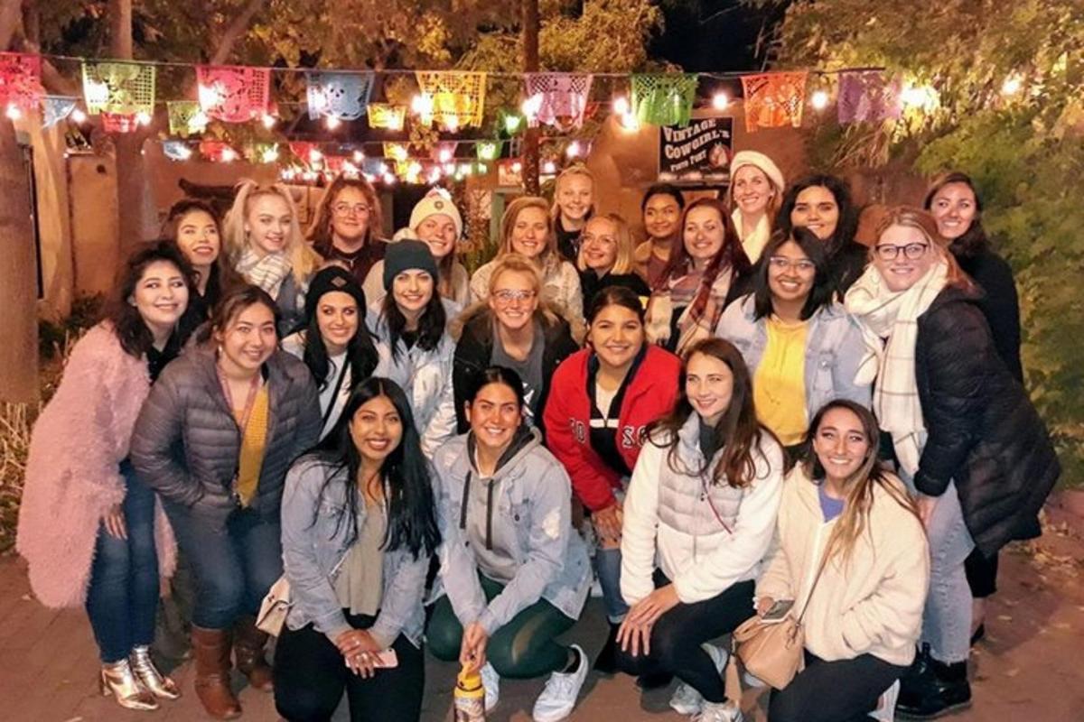 a group of people posing for a picture at night