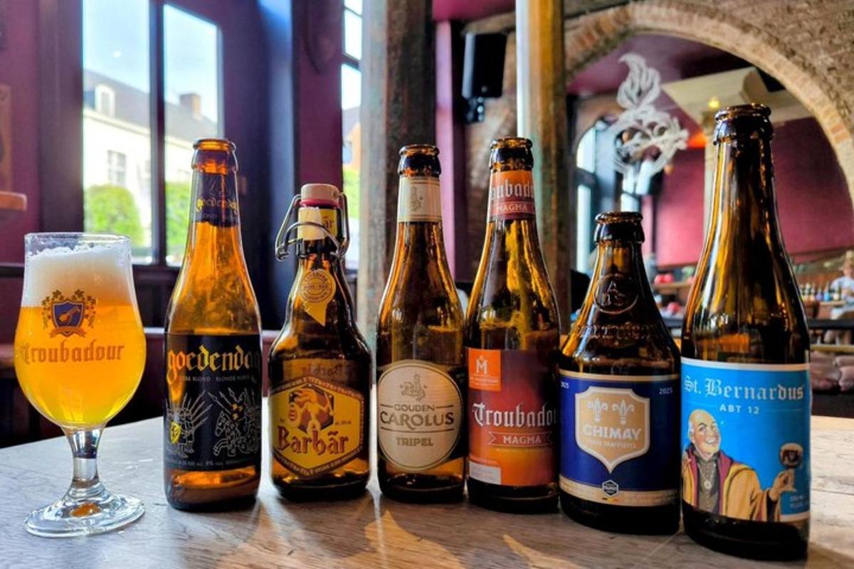 a group of beer bottles on a table with a glass