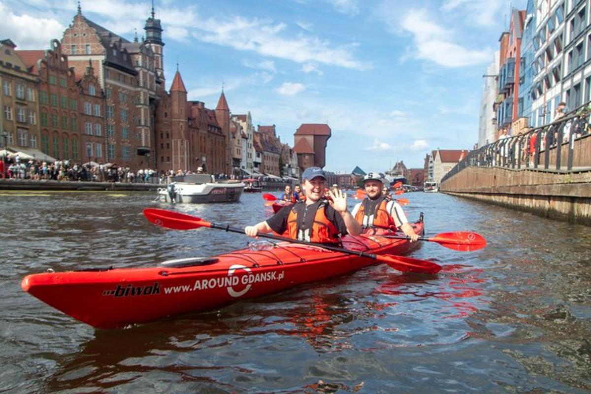two people in a red kayak on a river