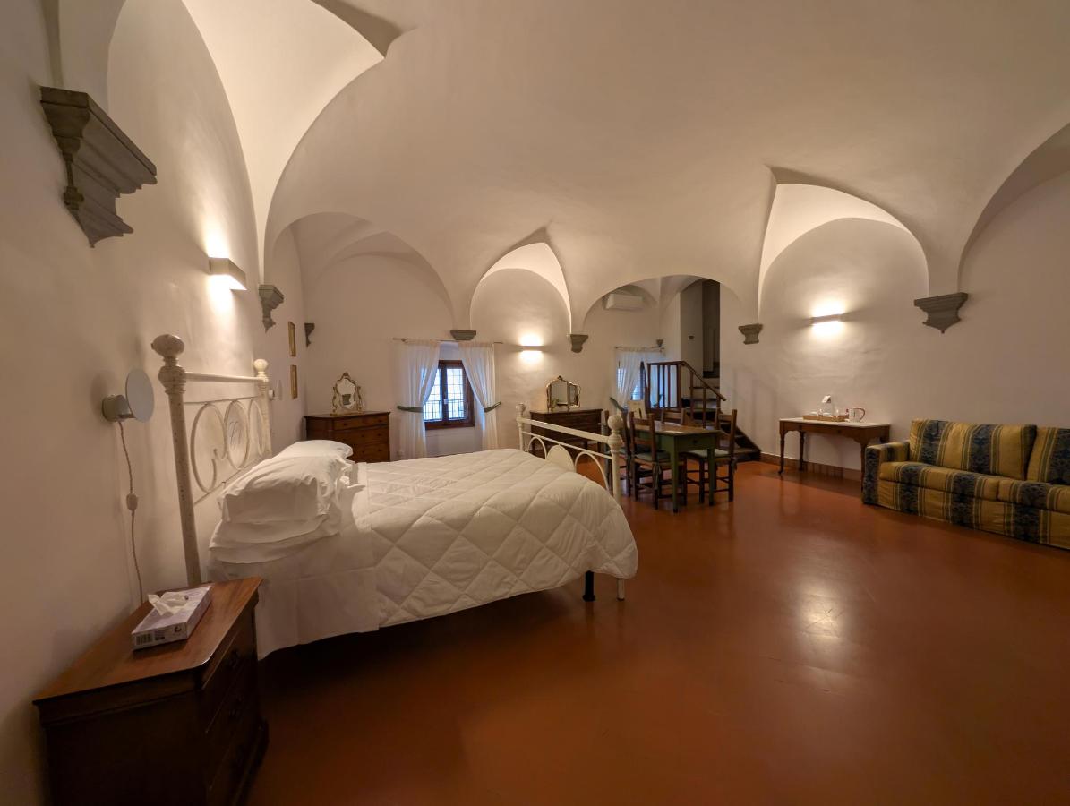 Letto o letti in una camera di Castello Vicchiomaggio