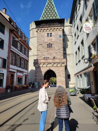 two people standing in front of a building with a tower