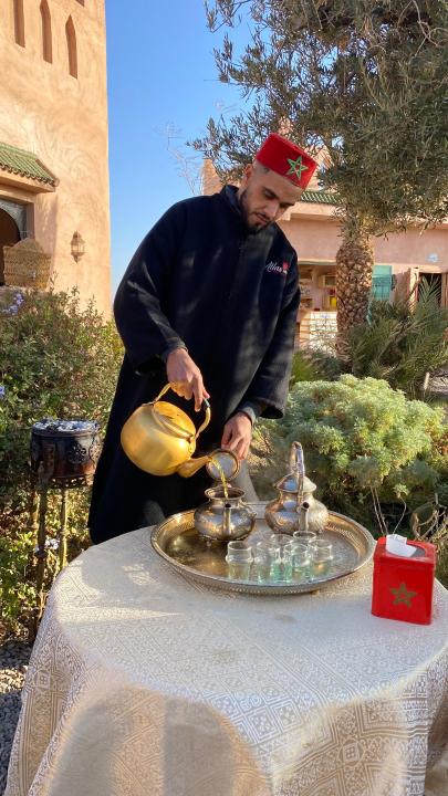 a man standing next to a table with a fountain